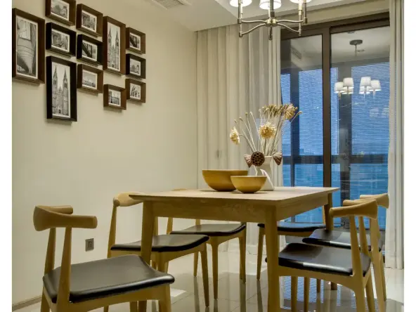 绕进餐厅,色泽淡雅,线条圆润流畅的实木餐桌上摆放着几口天然的木碗